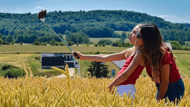 2 vrouwen maken foto met selfiestick
