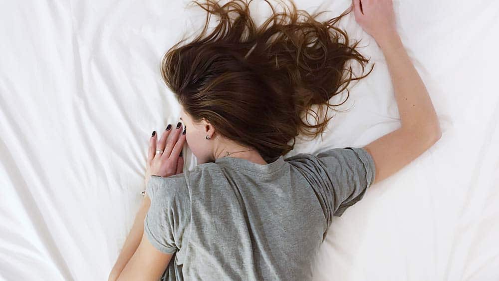 Vrouw slaapt op een wit matras